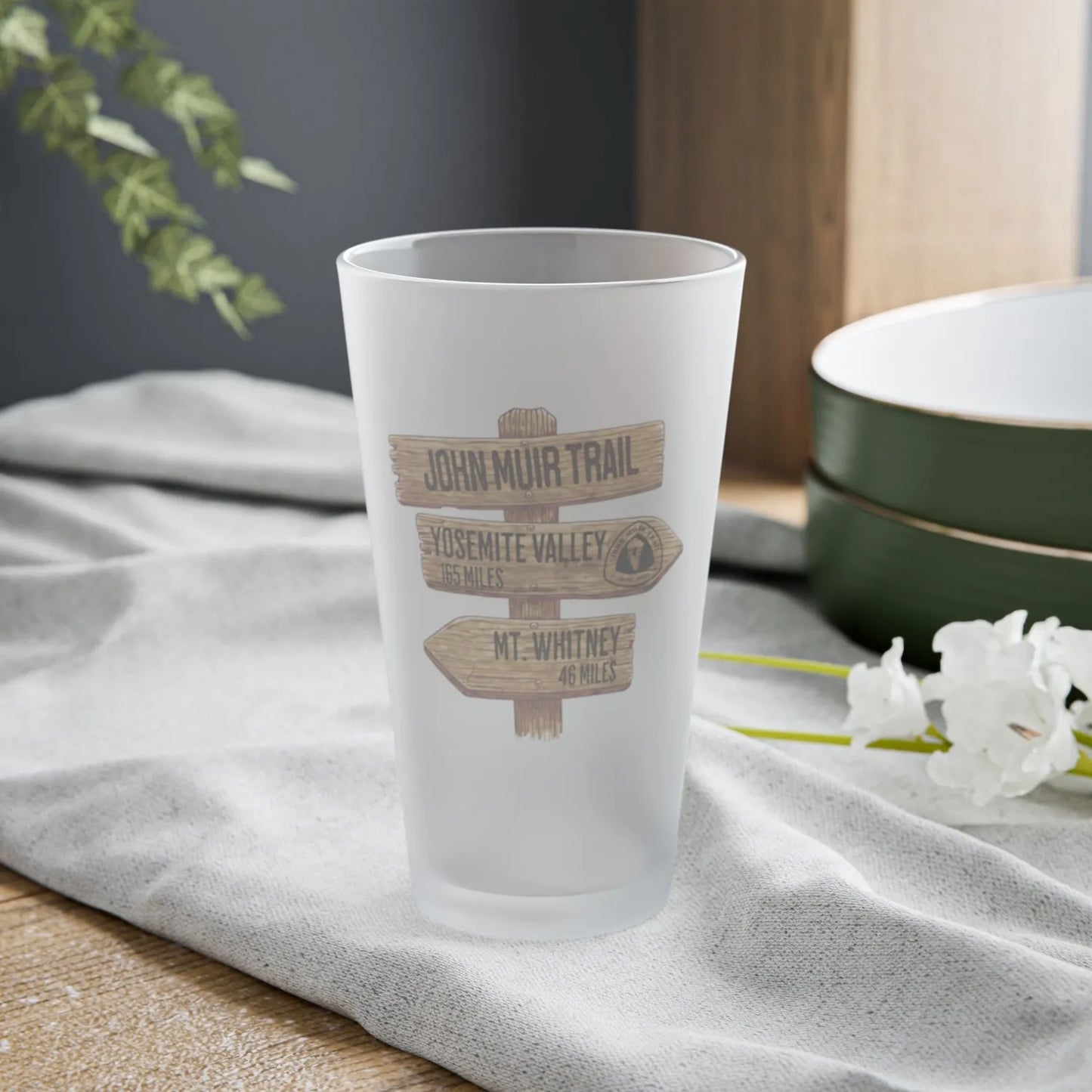 John Muir Trail wood mileage sign frosted pint glass shown from alternate product angle
