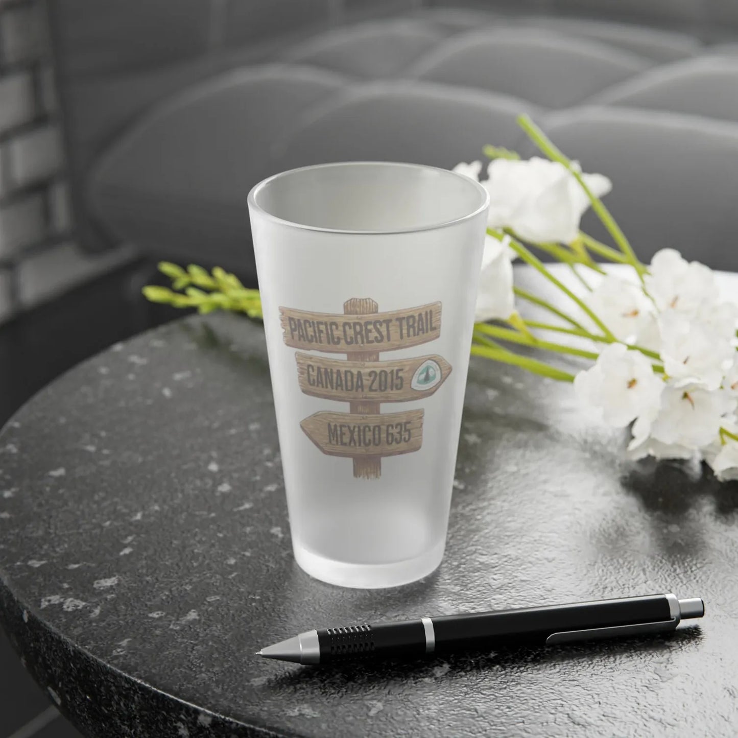 Pacific Crest Trail mileage sign frosted pint glass shown from alternate product angle
