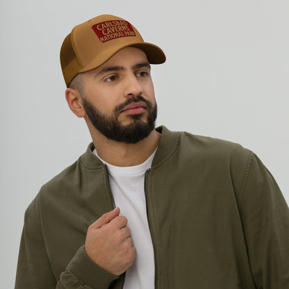 Carlsbad Caverns National Park sign embroidered trucker hat shown from alternate product angle