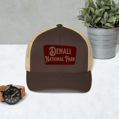Denali National Park sign embroidered trucker hat shown in lifestyle or modeled setting