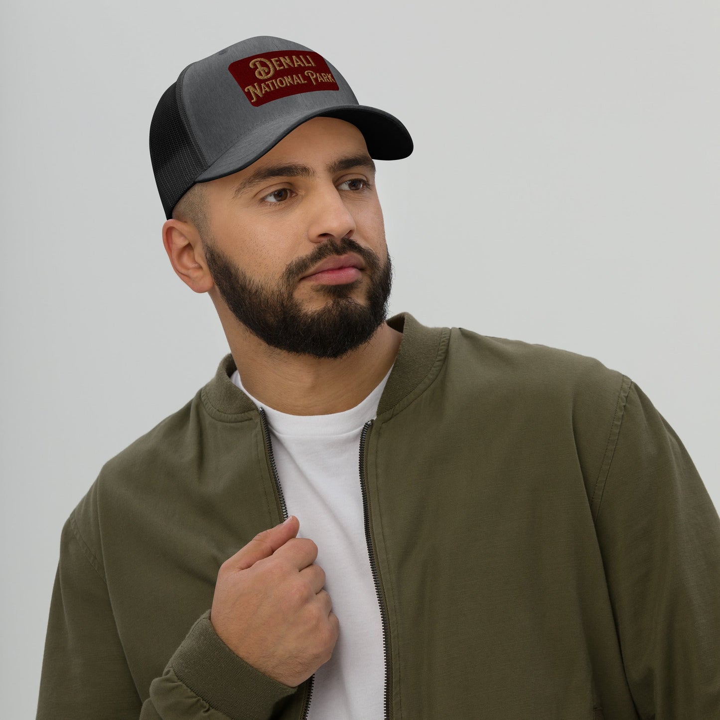 Denali National Park sign embroidered trucker hat shown in lifestyle or modeled setting
