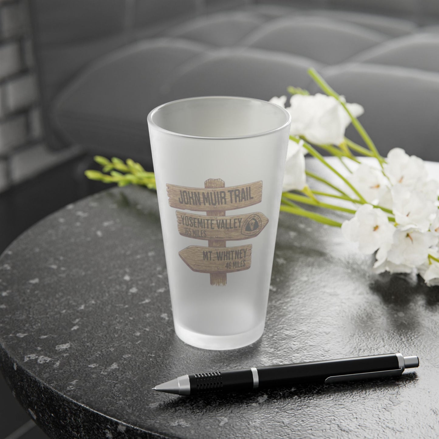 John Muir Trail wood mileage sign frosted pint glass shown from alternate product angle