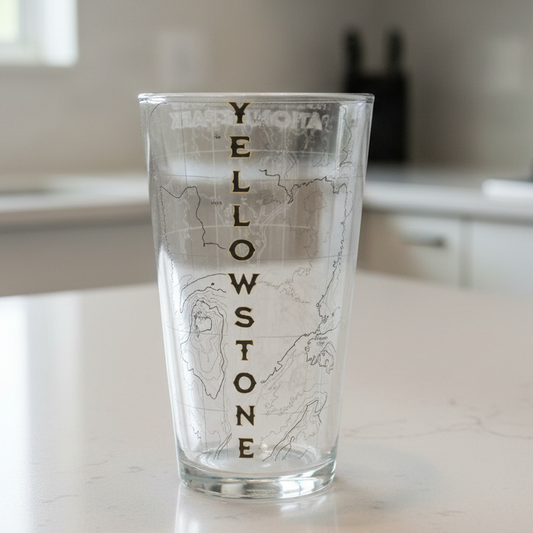 Glass with 'Yellowstone' engraving on a kitchen counter