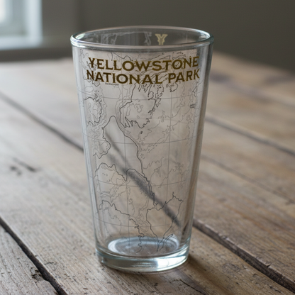 Clear glass with 'Yellowstone National Park' text on a wooden surface
