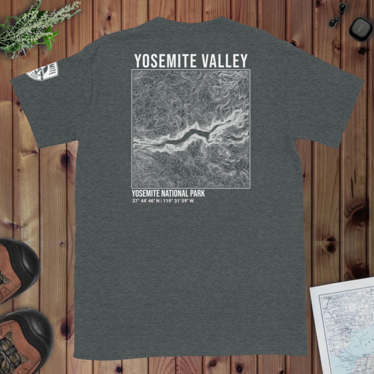 Gray t-shirt with Yosemite Valley design on a wooden surface