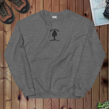 Gray sweatshirt with Redwood National Park logo on a wooden surface
