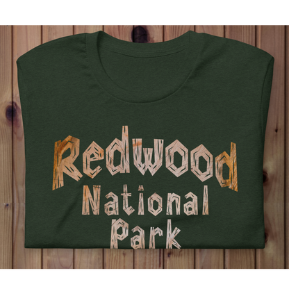 Green t-shirt with 'Redwood National Park' text on a wooden background