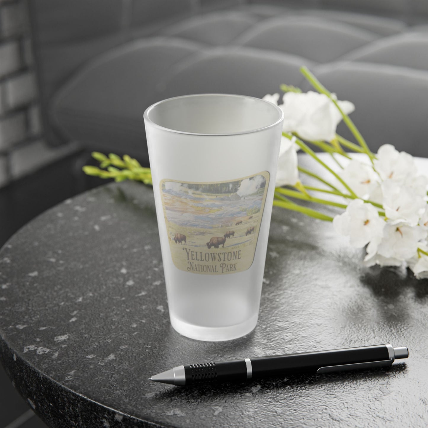 Yellowstone National Park wood sign frosted pint glass shown from alternate product angle